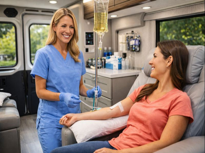 Woman receiving an IV treatment in a medical setting with a nurse.